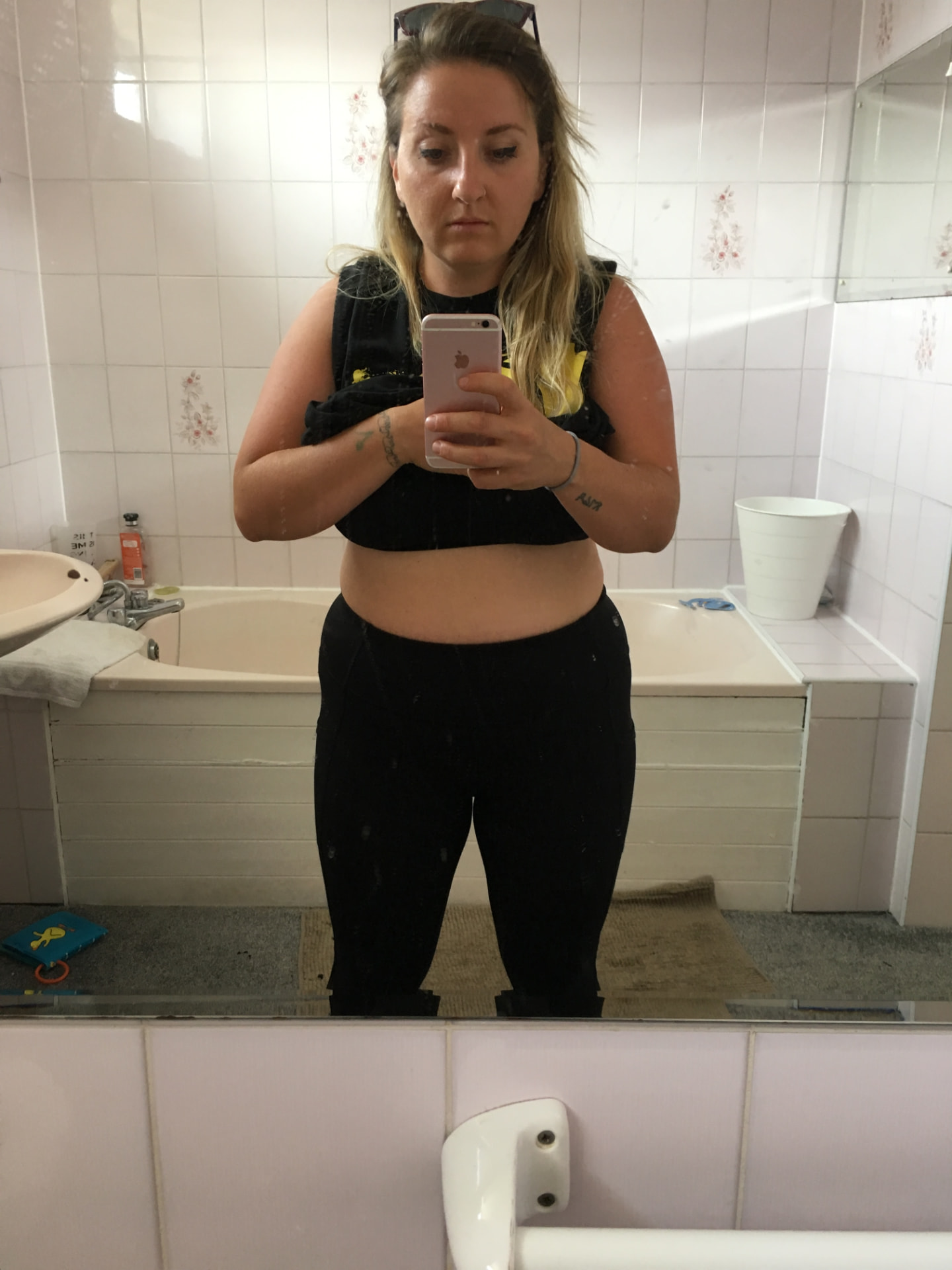 Ami in her twenties taking a bathroom mirror selfie