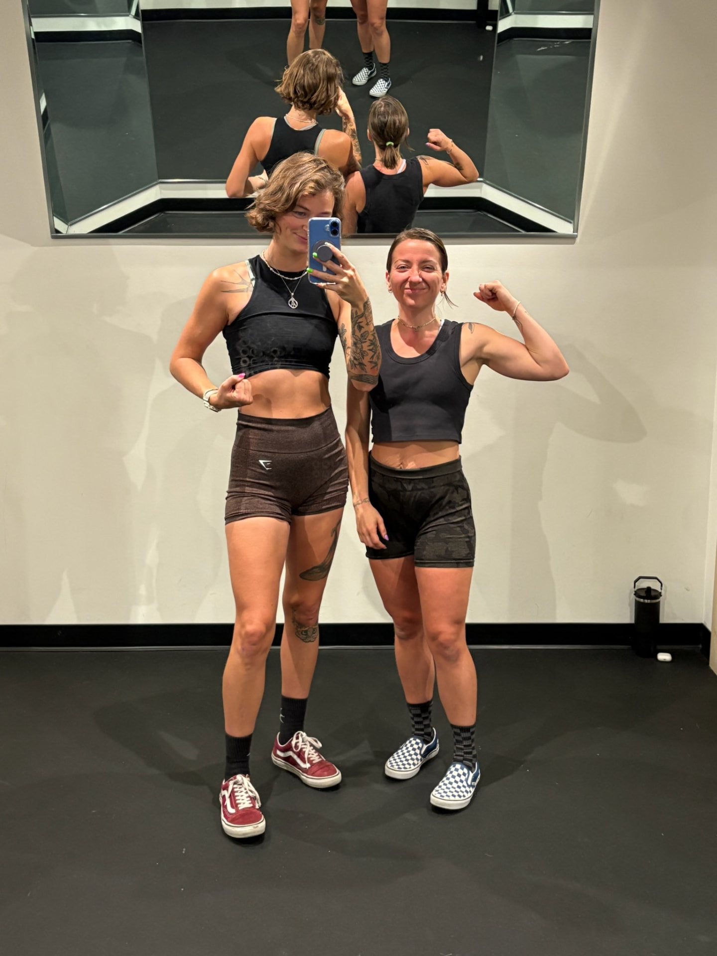 Ami and Chelsea flexing together in the gym